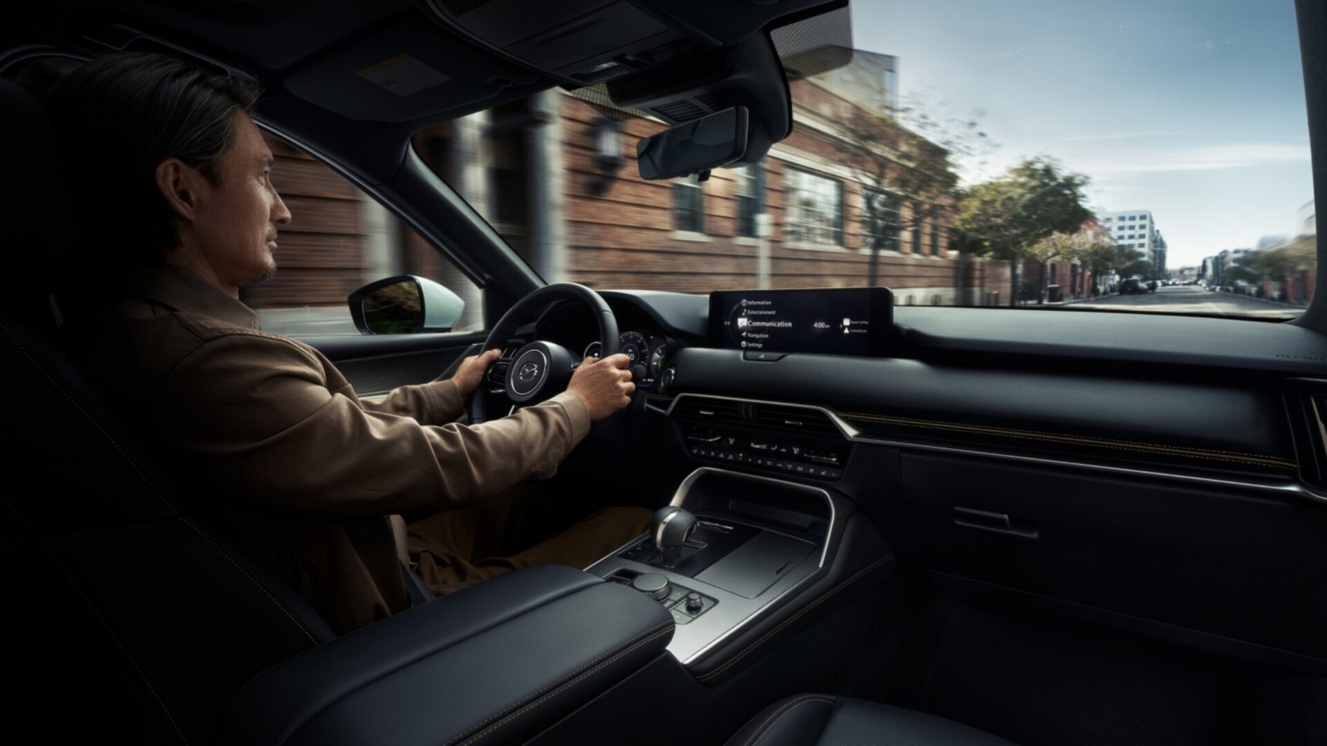 Male model in the driver seat of Mazda CX-90